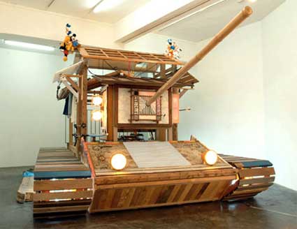 a wooden temple turned into a tank and adorned with waste material
