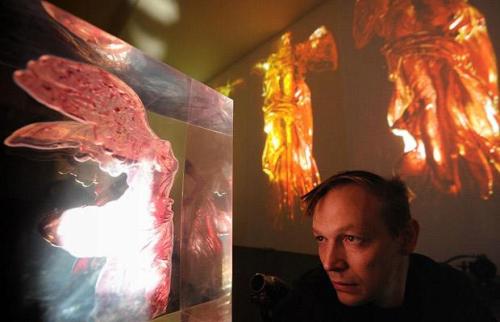 Russian artist Andrei Molodkin poses near his installation "The Red and the Black"