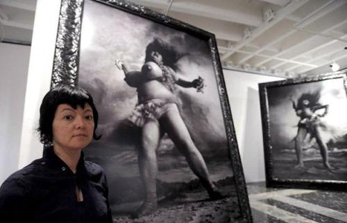 Miwa Yanagi poses next to her artwork "Windswept Women" on display in the Japanese pavilion