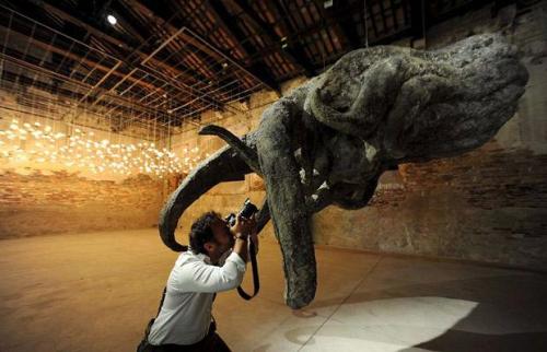 A photographer takes pictures of the artwork "Buddha's Hands" by Korean artist Han Yong Ping